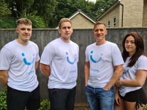 Four people wearing white Cystinosis Foundation UK t-shirts.